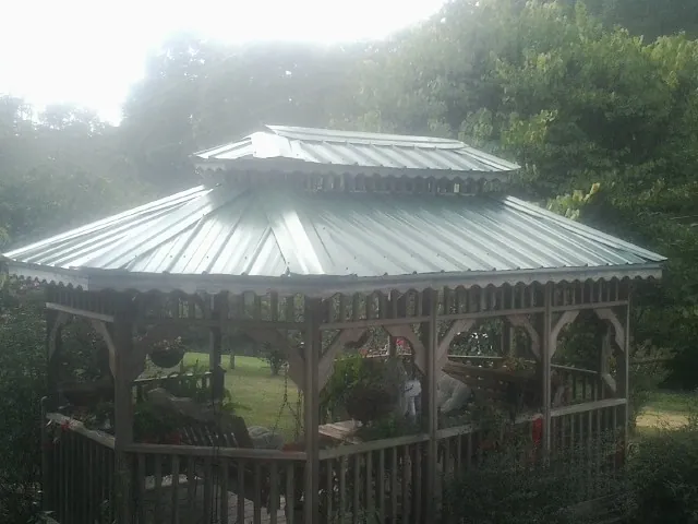 Two tier green metal roof on a garden gazebo in Coeymans